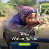 young girl drinking water happily from water pump
